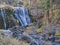 Autumn foliage surrounds the Middle Falls on the McCloud River in the Shasta Trinity National Forest, California, USA