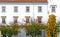 Autumn foliage and white facade