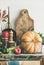 Autumn food ingredients and utensils over cupboard chest, vertical composition