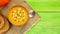 Autumn food. Pumpkin puree soup, bright slime green wooden table, top view, copy space