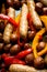 Autumn foodie: grilled sausages with pumpkin slices, potato and bell pepper on the wooden background