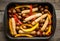 Autumn foodie: grilled sausages with pumpkin slices, potato and bell pepper on the wooden background