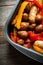 Autumn foodie: grilled sausages with pumpkin slices, potato and bell pepper on the wooden background