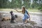 In the autumn forest  a little girl is training a French bulldog