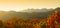 Autumn forest on the mountain range at sunrise