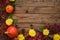 Autumn frame - red leaves, pumpkins, flowers on a wooden background top view. copy space for inscriptions, top view