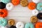 Autumn frame of various colorful pumpkins on white wood