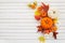 Autumn framework from pumpkins, berries and leaves on a travertine background. Concept of Thanksgiving day or Halloween.