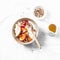 Autumn fruit and greek yogurt breakfast bowl. Persimmon, apple, walnuts, pomegranates and natural yogurt. Healthy food concept on