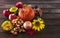 Autumn fruits and vegetables background. Harvest of ripe apples, grapes, plums, nuts and pumpkins on a dark wooden background.