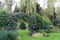 Autumn garden landscape with a decorative arch.