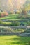 Autumn garden with lawns, retaining walls, alpine slide