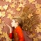 Autumn girl on dried leaves blowing wind lips