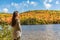 Autumn girl enjoying watching nature forest lake