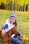 Autumn girl in poplar tree forest playing with dog