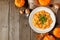 Autumn gnocchi with a pumpkin cream sauce, above table scene over wood with copy space