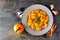 Autumn gnocchi with pumpkin cream sauce, top view table scene over slate