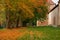 Autumn golden foliage October season day time park outdoor alley way trail near old castle wall facade