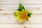 Autumn golden orange, yellow and green leaves in heap on natural wooden table