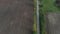 Autumn gravel road in farmland, aerial