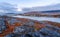 Autumn greenlandic orange tundra landscape with lake and mountains in the background, Nuuk