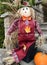 Autumn and Halloween decorative doll with pumpkin in front of the house
