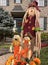 Autumn and Halloween decorative family dolls with flowers in front of the house