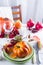 Autumn Halloween or thanksgiving day table setting. Fallen leaves, pumpkins, spices, empty plate and cutlery on wooden