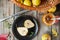 Autumn harvest concept - cut fresh ripe pear on the black plate and group of yellow pears in the basket and on the rustic wooden t