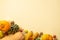 Autumn harvest concept. Top view photo of raw vegetables pumpkins gourd maize pattypans walnuts and physalis on isolated beige