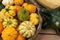 Autumn harvest in a farm market. Decorative pumpkins in a basket