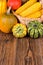 Autumn harvest festival motive with two different gorgonzola pumpkins and others in front of a basket with corn cobs