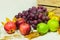 Autumn harvest. Fruits and fallen maple leaves on white tabletop