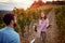 Autumn harvest grapes. man and woman on autumn vineyard tasting wine