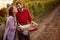 Autumn harvest grapes. Winegrower couple in vineyard