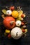 Autumn Harvest and Holiday still life. Happy Thanksgiving Background. Selection of various pumpkins on dark wooden background.