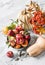 Autumn harvest - ripe red apples, pumpkins, zucchini on a light marble background, top view