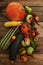 Autumn harvest of vegetables and fruits on a wooden board. Pumpkin, melon, zucchini, tomatoes, apples and peppers. Vitamins from