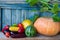 Autumn harvest vegetables: pumpkin, watermelon, corn, peppers, eggplant, tomatoes on a wooden table