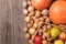 Autumn harvests arranged od the right side of the frame on old wooden boards. Top view of vegetables and fruits. Free space.