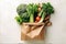 Autumn healthy vegetables in shopping paper bag on white background, top view. AI generated