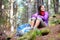 Autumn hiking - woman hiker resting in forest