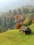 Autumn hills with old house