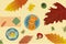 Autumn holiday time buns and donuts on plates apples yellow red green leaves