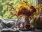 Autumn home still life on the window - a bouquet of mountain ash in a jug, a lit candle, a pumpkin. Cozy home interior