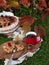 Autumn homemade apple pie with raspberries, next to a slice of pie on a wooden plate,