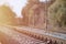 Autumn industrial landscape. Railway receding into the distance among green autumn trees