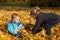 Autumn item: brother and sister having fun in autumn playing wit