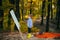 Autumn kid. Start new picture. Painter with easel and canvas. Cute little boy in the forest painting his first paintings