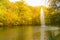 Autumn lake landscape view,  fountain and yellow trees